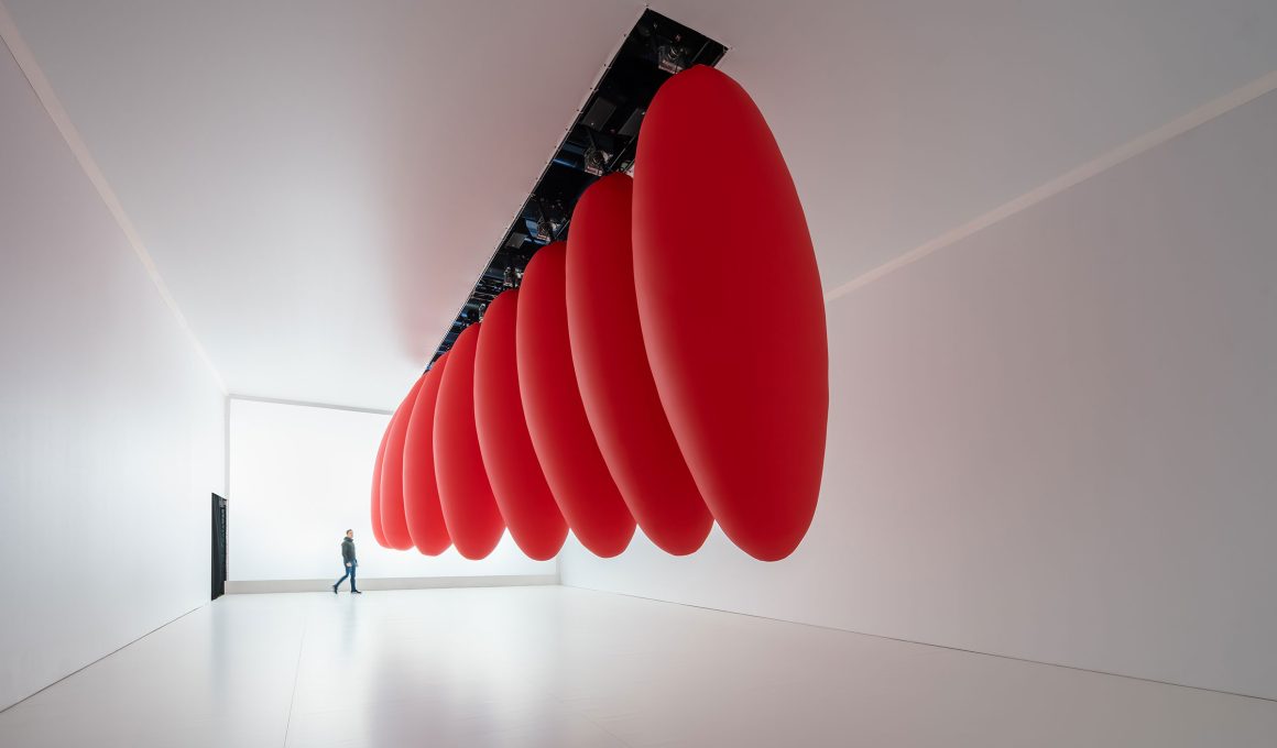 SpY's kinetic installation Ovoids, featuring eight red ovoids suspended in pendular motion. 1 Photo by Ruben PBescos.  